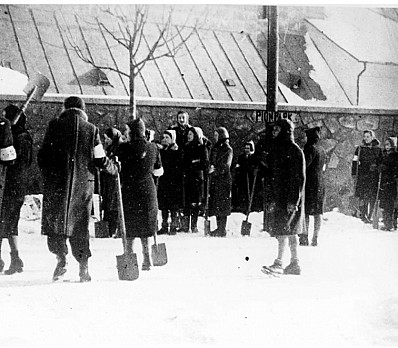 Women huddled in labor camp